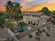 Aerial view of private backyard with a sparkling pool, lush tropical plants, and privacy fence at 1360 S Camellia Ct, Chandler, AZ 85286