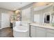 Bright bathroom showcasing a soaking tub, double sink vanity and wood-look floors at 1360 S Camellia Ct, Chandler, AZ 85286