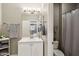 Updated bathroom featuring a white vanity, framed mirror, and a tiled shower-tub combination at 1360 S Camellia Ct, Chandler, AZ 85286