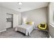 Cozy bedroom featuring a comfortable bed with yellow accents and a closet with sliding doors at 1360 S Camellia Ct, Chandler, AZ 85286