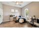 Inviting bedroom with a ceiling fan, a cozy bed, and bright natural light from the window at 1360 S Camellia Ct, Chandler, AZ 85286