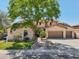 Charming two-story home with a three car garage, lush landscaping, and mature shade tree at 1360 S Camellia Ct, Chandler, AZ 85286