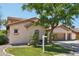 Charming two-story home with a three car garage, lush landscaping, and mature shade tree at 1360 S Camellia Ct, Chandler, AZ 85286