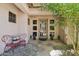 Inviting front entrance featuring a decorative bench, stone walkway, and beautiful door with glass panels at 1360 S Camellia Ct, Chandler, AZ 85286