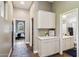 Hallway featuring built-in cabinets, leading to a well-lit bathroom and bedroom for seamless living at 1360 S Camellia Ct, Chandler, AZ 85286