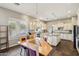 Bright eat-in kitchen featuring granite countertops, a center island, lots of cabinet space and tile flooring at 1360 S Camellia Ct, Chandler, AZ 85286