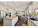 Open kitchen showcases granite counters, white cabinets, a center island, and a view of the dining and living areas at 1360 S Camellia Ct, Chandler, AZ 85286