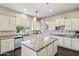 Beautiful kitchen features white cabinets, stainless steel appliances, granite counters, and pendant lighting at 1360 S Camellia Ct, Chandler, AZ 85286