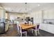 Eat-in kitchen features white cabinets, granite countertops, and a wood table with purple chairs at 1360 S Camellia Ct, Chandler, AZ 85286