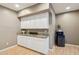 Kitchenette showcases a granite countertop, white cabinets, and a mini-refrigerator at 1360 S Camellia Ct, Chandler, AZ 85286