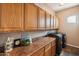 Functional laundry room with cabinets above the counter and side-by-side washer and dryer at 1360 S Camellia Ct, Chandler, AZ 85286
