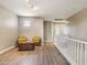 An upstairs loft area featuring wood floors, two chairs, and a small table at 1360 S Camellia Ct, Chandler, AZ 85286