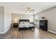 Main bedroom suite features wood-look floors, ceiling fan and comfortable bedding at 1360 S Camellia Ct, Chandler, AZ 85286