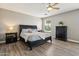 Large main bedroom suite features ceiling fan, wood-look flooring and designer furnishings at 1360 S Camellia Ct, Chandler, AZ 85286