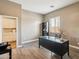Office space with a large desk, hardwood floors and bright lighting at 1360 S Camellia Ct, Chandler, AZ 85286