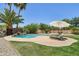Relaxing poolside scene featuring lounge chairs, a sun umbrella, and lush landscaping at 1360 S Camellia Ct, Chandler, AZ 85286