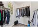 Well-organized walk-in closet with rods and shelving for optimal storage and arched window for natural light at 1360 S Camellia Ct, Chandler, AZ 85286