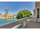 Balcony overlooks a wide canal and beautiful waterfront homes amidst lush greenery at 1414 W Coral Reef Dr, Gilbert, AZ 85233