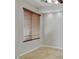 Bedroom with wood-look blinds over a window, tile floors, and neutral paint at 1414 W Coral Reef Dr, Gilbert, AZ 85233
