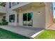 Home's rear patio with sliding glass doors leading to a lake view at 1414 W Coral Reef Dr, Gilbert, AZ 85233