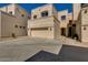 Exterior view of townhome, featuring a two-car garage and neutral stucco at 1414 W Coral Reef Dr, Gilbert, AZ 85233