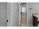 Hallway featuring tile floors, connecting the bathroom and a bedroom with natural light at 1414 W Coral Reef Dr, Gilbert, AZ 85233