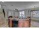 Kitchen island with dark wood cabinets and views of the living room and staircase at 1414 W Coral Reef Dr, Gilbert, AZ 85233