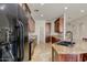 Open kitchen layout showcasing granite counters, wood cabinets, and black appliances at 1414 W Coral Reef Dr, Gilbert, AZ 85233