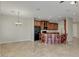 Open kitchen with dark wood cabinets, a breakfast bar and tile flooring at 1414 W Coral Reef Dr, Gilbert, AZ 85233