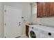 Laundry room with washer, dryer, sink, cabinets, and exterior door at 1414 W Coral Reef Dr, Gilbert, AZ 85233