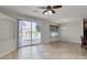 Open living room with lake view through sliding doors, tile floors and a ceiling fan at 1414 W Coral Reef Dr, Gilbert, AZ 85233