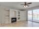 Open living room with lake views, fireplace and built in niches, featuring tile flooring at 1414 W Coral Reef Dr, Gilbert, AZ 85233