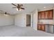 Spacious living room featuring ceiling fans and built-in wet bar at 1414 W Coral Reef Dr, Gilbert, AZ 85233