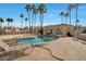 Community pool surrounded by palm trees and lounge chairs at 1414 W Coral Reef Dr, Gilbert, AZ 85233