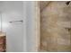 Walk-in shower features earth-toned tile, decorative accent strips and a built-in corner shelf at 1414 W Coral Reef Dr, Gilbert, AZ 85233