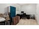 Bedroom with neutral walls, carpet floors, and a desk area providing a functional and versatile space at 14907 N 177Th Ave, Surprise, AZ 85388