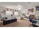Spacious bedroom with fan, large window, and carpeted flooring, offering lots of versatile space at 15910 W Shangri La Rd, Surprise, AZ 85379