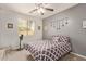 Bright bedroom with ceiling fan, carpet, and a large window, providing ample natural light at 15910 W Shangri La Rd, Surprise, AZ 85379