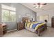 Bedroom with neutral colored walls, carpet, ceiling fan and two windows at 15910 W Shangri La Rd, Surprise, AZ 85379