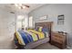 Spacious bedroom features neutral colored walls, carpet, ceiling fan and access to the ensuite bathroom at 15910 W Shangri La Rd, Surprise, AZ 85379