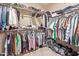 Walk-in closet with plenty of space for storage and organization, with clothes hanging on rods and shelves at 15910 W Shangri La Rd, Surprise, AZ 85379