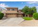 Two-story home with a well-manicured lawn, three car garage and brick accents at 15910 W Shangri La Rd, Surprise, AZ 85379