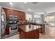 Kitchen with wooden cabinets, a central island, granite countertops, and stainless appliances at 15910 W Shangri La Rd, Surprise, AZ 85379