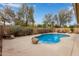 Inviting backyard pool with a rock feature and lush landscaping, creating a tranquil and private oasis at 15910 W Shangri La Rd, Surprise, AZ 85379