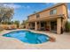 Spacious backyard with a large pool, covered patio, and outdoor dining area, ideal for entertaining at 15910 W Shangri La Rd, Surprise, AZ 85379