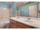 Well-lit bathroom features a double sink vanity, bathtub with shower, and a large mirror at 16527 N 71St Dr, Peoria, AZ 85382