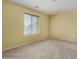 Bright bedroom with large window and neutral carpet, ideal for relaxation and personal space at 16527 N 71St Dr, Peoria, AZ 85382