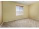 Comfortable bedroom with large window offering natural light, and neutral carpet flooring at 16527 N 71St Dr, Peoria, AZ 85382