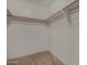 A walk-in closet providing ample storage, featuring hanging rods and shelves, perfect for organization at 16527 N 71St Dr, Peoria, AZ 85382