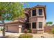 Two-story home with a neutral color scheme, well-maintained landscaping, and a two-car garage at 16527 N 71St Dr, Peoria, AZ 85382